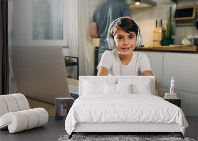 portrait of a young Caucasian boy happy to take online classes from home. Wall mural