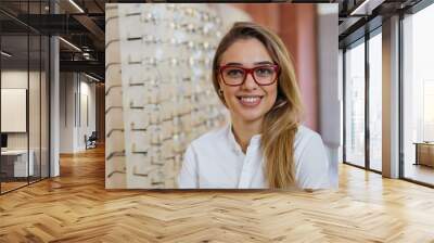 portrait of woman wearing glasses in optic store Wall mural