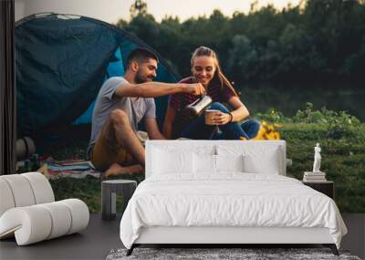 romantic couple on camping by the river outdoors Wall mural