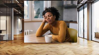 Sleepy woman having her morning coffee Wall mural