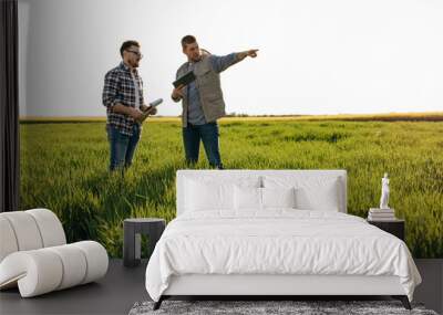 Two farmers are controlling grows of grain field Wall mural