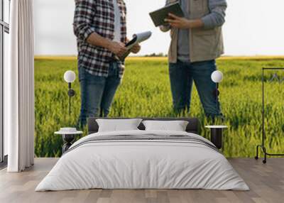 Two farmers monitoring grain field using digital tablet Wall mural