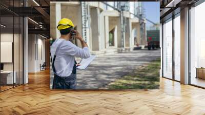 worker controlling grain loading on agricultural farm Wall mural