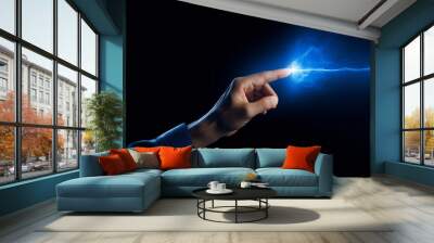 A human finger touching a spark of electrical energy illustrating a concept of power and connection.  Futuristic technology of information transfer Wall mural