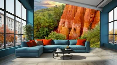 In Roussillon, France, a dramatic cliff of variegated red, orange and yellow ochre pigments in the forested area on the edge of the village, in the Luberon region of Provence. Wall mural