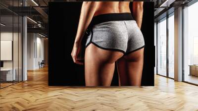 closeup woman buttocks over dark Wall mural