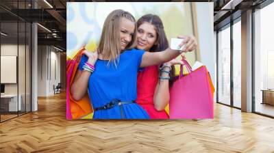 two woman taking pictures of themselves Wall mural