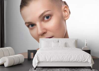 Young beauty woman with shaved temple. Studio portrait. Healthcare, skincare concept on the white background Wall mural