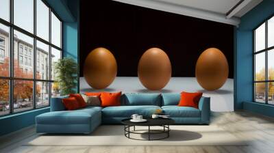 3 eggs on a white area, spaced apart .social disstancing Wall mural