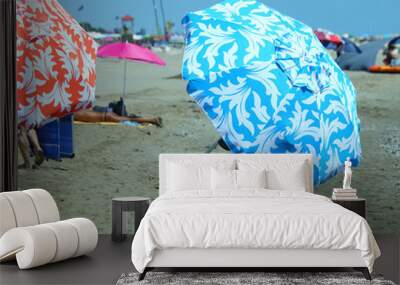 holiday makers move on the hot sand with beach umbrellas Wall mural