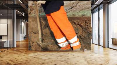 man with high visibility clothing while working for laying techn Wall mural