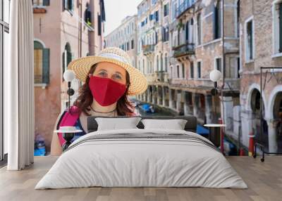 woman with surgical mask and the straw hat during a trip to Veni Wall mural