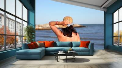 young nice woman with boater by the sea in summer Wall mural