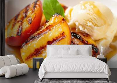 Grilled peaches with ice cream served on a plate, garnished with a mint leaf, showcasing a delicious summer dessert. Wall mural