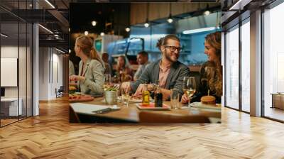 Group of friends sitting in retaurant and eating dinner. Wall mural