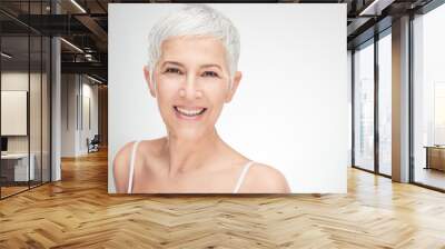 Portrait of beautiful senior woman in front of white background. Wall mural