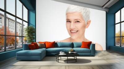 Portrait of beautiful senior woman in front of white background. Wall mural