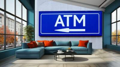 ATM sign on wall pointing with an arrow direction of cash point concept banking and finance Wall mural