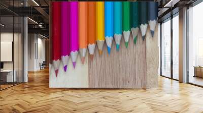 Coloured pencils against a wooden background Wall mural