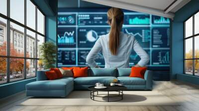 A sharpeyed businesswoman studies sleek holographic charts in a hightech setting, highlighting the power of analytics. Wall mural