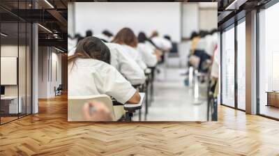 School exam student's taking educational test, admission test, thinking hard, writing answer in university classroom, education and world literacy day concept Wall mural