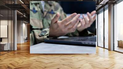 close up operator solider man hand try to explain about security system of mission to team by online meeting on laptop in operation room station for develop military technology and training concept Wall mural