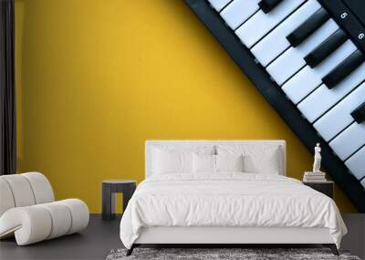 close up top view electric keyboard music instrument on yellow background concept Wall mural