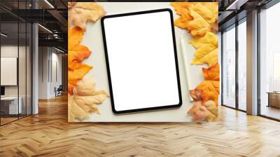 close up top view mockup of white  blank digital tablet screen and stylus pen with group of dried orange color maple leaves background texture or autumn season collection design concept Wall mural