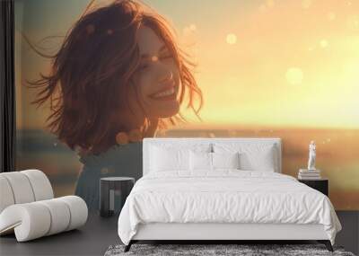 Close-up photo of a young woman with a smiling face, her hair blowing in the wind and the evening sunlight by the sea, with warm and relaxing light. Wall mural