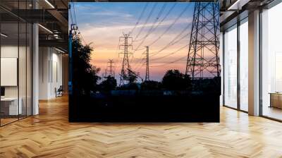 High Voltage Electric Poles and Transmission Towers in the sunrise. Wall mural