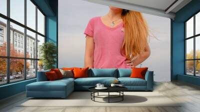 Vertical shot of a young Hispanic female in a pink summer outfit Wall mural