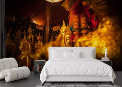 The face of the Golden Buddha Statue is Isolated on a wall Wall mural