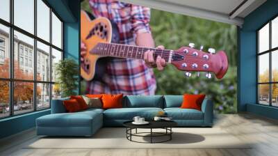 close up of young hipster woman practiced guitar in the park,happy and enjoy playing guitar  Wall mural