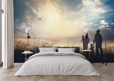 Family Day God concept: Silhouette people looking for the cross on autumn sunrise background Wall mural