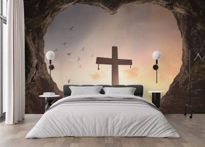 Good Friday concept: Heart shape of empty tomb stone with the cross over meadow sunrise background Wall mural