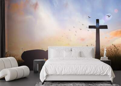 Good Friday concept: Silhouette of prayer woman bow down and praying over cross on sunset background Wall mural