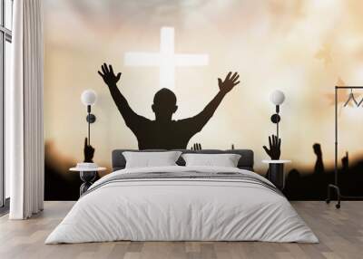 praise and worship concept: silhouette human raising hands to praying god on blurred white cross wit Wall mural