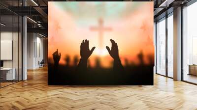 Worship concept: human rising hands over blurred cross background Wall mural