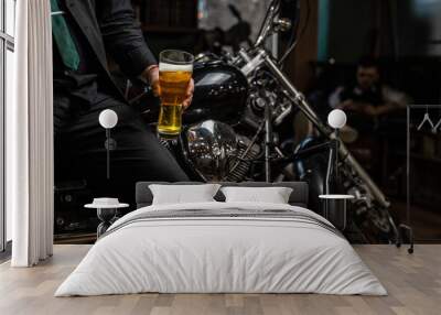 Biker sitting on a custom motorcycle with a glass of shiny craft beer. Chrome bike Wall mural