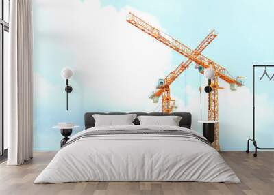 two orange crane in cross on blue sky Wall mural