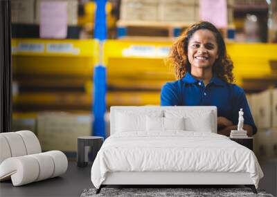 A close up portrait of women who working in the wearhouse storehouse, empower women, foreman, employee, working concept, american african brown curly hair.smiling ypung adult girl in uniform. Wall mural