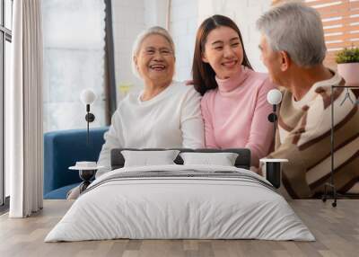 Capture the Joy of Family: Happy Grandparents Enjoying Retirement Indoors, Hugging Their Children and Grandchildren on a Couch, Sharing Smiles and Togetherness Across Generations Wall mural