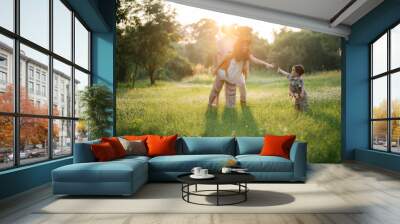 happy harmonious family outdoors concept father and mother and son have activities together on holidays, nature grassland field Wall mural