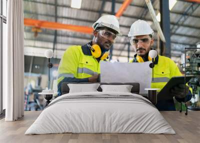 professional technician engineer with safety helmet hard hat working in industrial manufacturing factory, men at work to checking equipment of machinery production technology or construction operating Wall mural