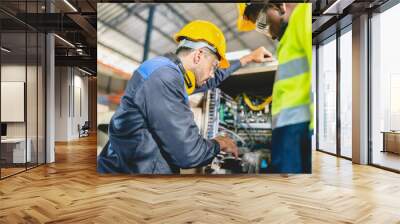 professional technician engineer with safety helmet hard hat working in industrial manufacturing factory, men at work to checking equipment of machinery production technology or construction operating Wall mural