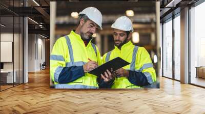 professional technician engineer with safety helmet hard hat working in industrial manufacturing factory, men at work to checking equipment of machinery production technology or construction operating Wall mural