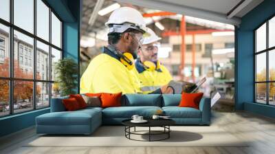 professional technician engineer with safety helmet hard hat working in industrial manufacturing factory, men at work to checking equipment of machinery production technology or construction operating Wall mural