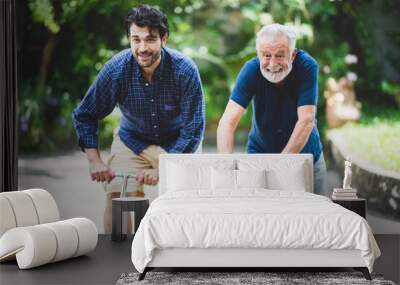 senior father and hipster adult son are happy love and relaxing together at nature outdoor park, mature family of elderly caucasian beard man playing fun with family in retirement leisure time Wall mural