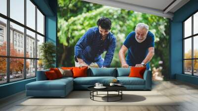 senior father and hipster adult son are happy love and relaxing together at nature outdoor park, mature family of elderly caucasian beard man playing fun with family in retirement leisure time Wall mural