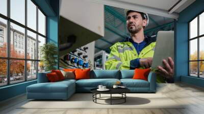 technician engineer working to maintenance a construction equipment industry, production technology in plant factory, man working to safety control system in manufacturing product factory Wall mural